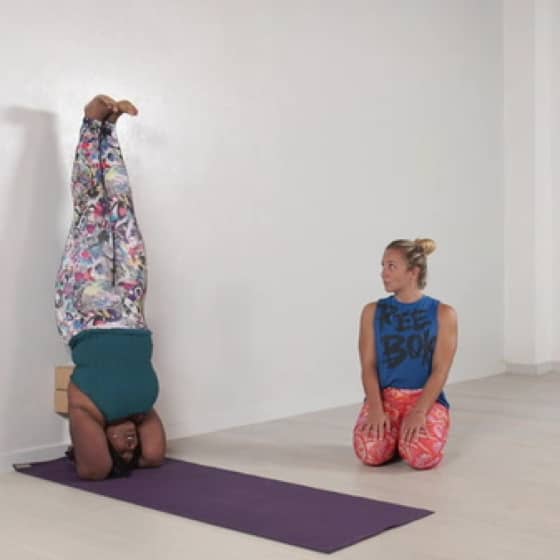 Dianne demonstrates how to do headstand at the wall.