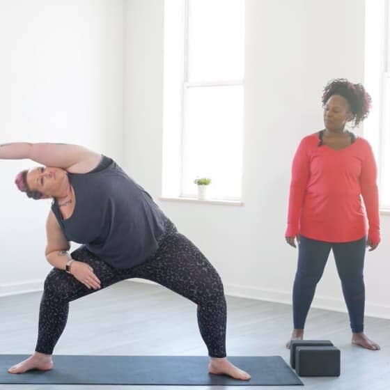 Dianne leads student through goddess pose variation.