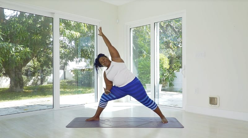 Dianne wears striped blue leggings in side angle pose.